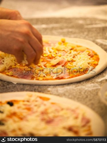 Making Pizza in restaurant, close up hands of chef