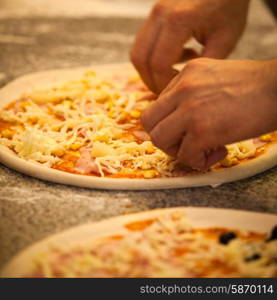 Making Pizza in restaurant, close up hands of chef