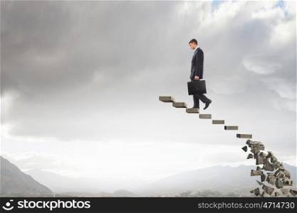 Making risky steps. Businessman climbs steps of collapsing financial ladder