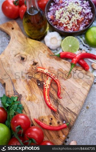 making salsa dip sauce - sliced chili pepper on wooden cutting board.. making salsa dip sauce - sliced chili pepper on wooden cutting board