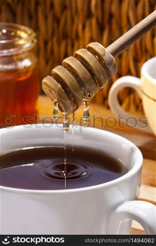 Making tea with honey.