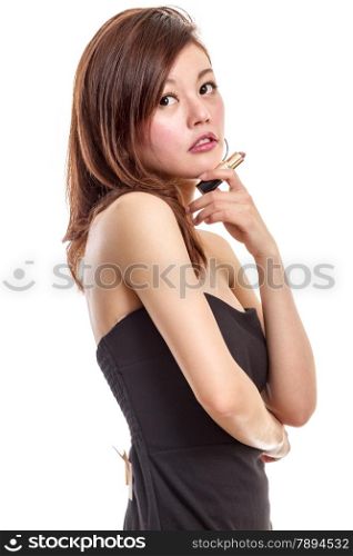 Malay woman in black dress putting on makeup