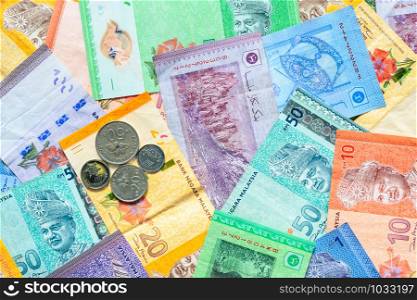 Malaysia currency of Malaysian ringgit banknotes and coins background. Sen coins of fIve, ten, twenty and fifty on paper money of one, five, ten, twenty, fifty and hundred ringgit notes.