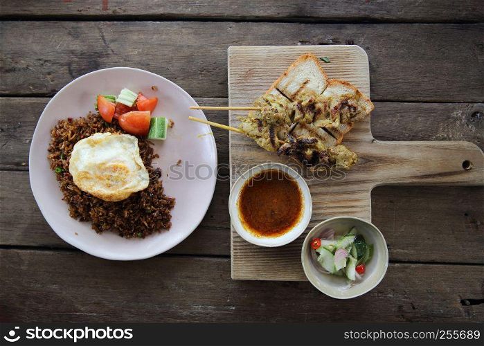 Malaysian food chicken satay with peanut sauce on wood background
