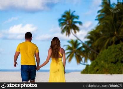 Maldives, a couple walking along the beach