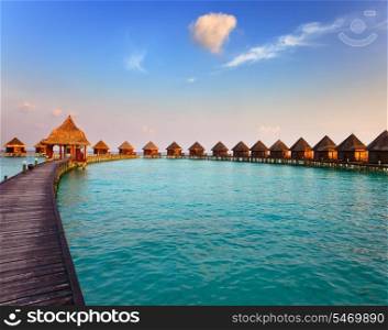 Maldives. Villa on piles on water at the time sunset.