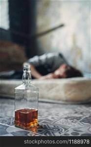 Male alcohol addict sleeping on mattress. Addiction concept, drunk addicted people. Male alcohol addict sleeping on mattress