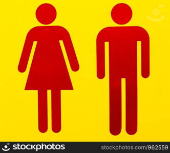 male and female as often used to indicate restrooms with two silhouetted figures standing side by side on yellow