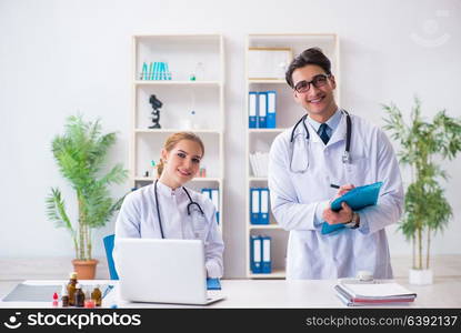 Male and female doctor having discussion in hospital