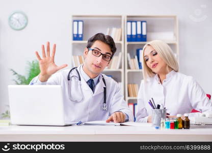 Male and female doctor having discussion in hospital