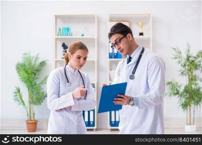 Male and female doctor having discussion in hospital