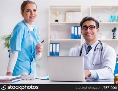 Male and female doctor having discussion in hospital. The male and female doctor having discussion in hospital