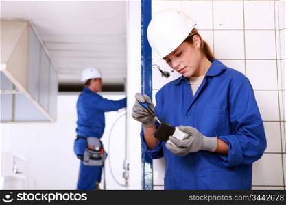 Male and female electricians working together