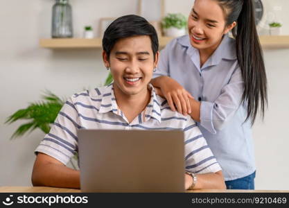 Male and female employees work together happily in the office.