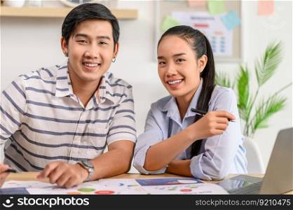 Male and female employees work together happily in the office.