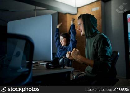 Male and female hackers works on computers in darknet, dangerous teamwork. Illegal web programmer at workplace, criminal occupation. Data hacking.. Male and female hackers works in darknet