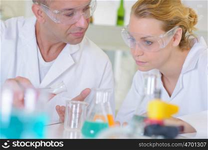 Male and female lab technicians conferring