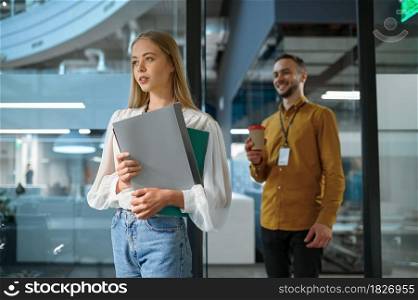 Male and female managers, meeting in IT office. Professional teamwork and planning, group brainstorming and corporate work, modern company interior on background. Male and female managers, meeting in IT office