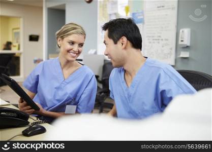 Male And Female Nurse Working At Nurses Station