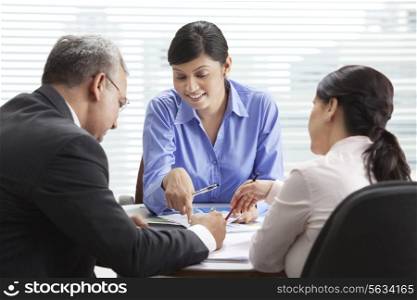 Male and female professionals discussing in meeting