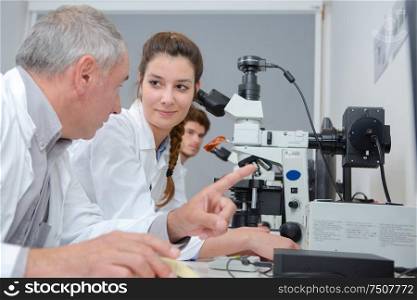 male and female scientists working in research facility