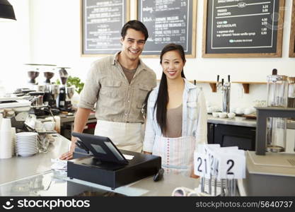 Male And Female Staff In Coffee Shop