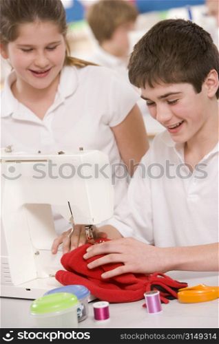 Male and female student using sewing machine