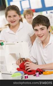 Male and female student using sewing machine