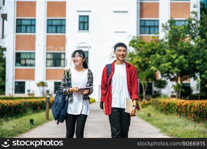 Male and female students wear a face Chill and stand in front of the university.