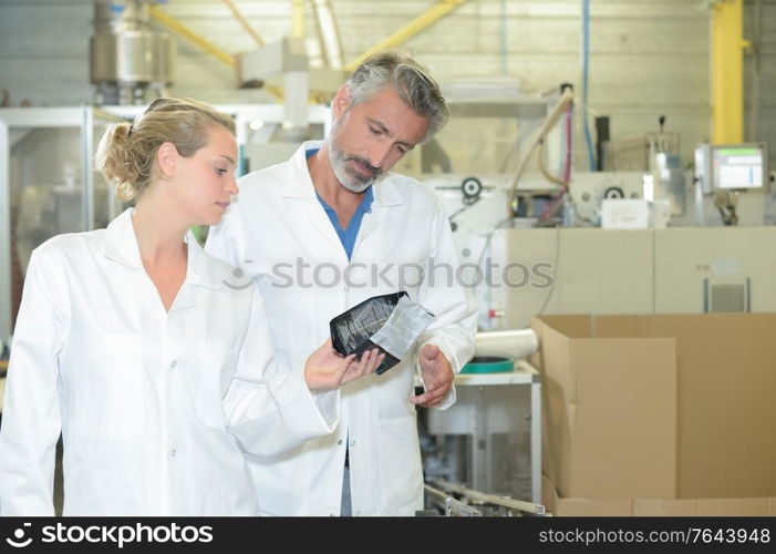 male and female technician in factory