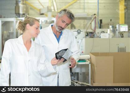 male and female technician in factory