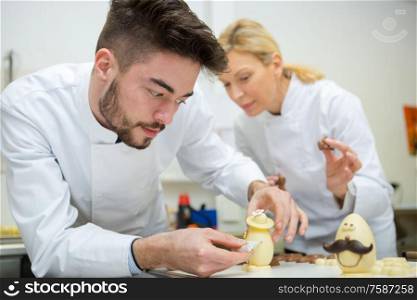 male and female worker making chocolate