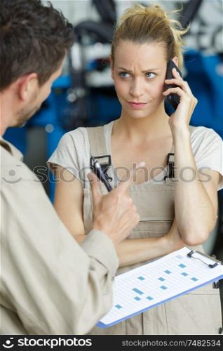male and female worker talking over the phone