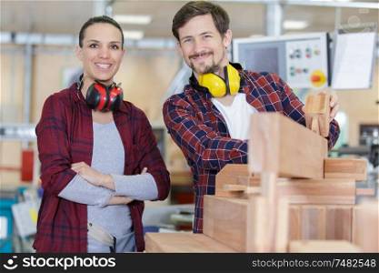 male and female workers in woodworking workshop