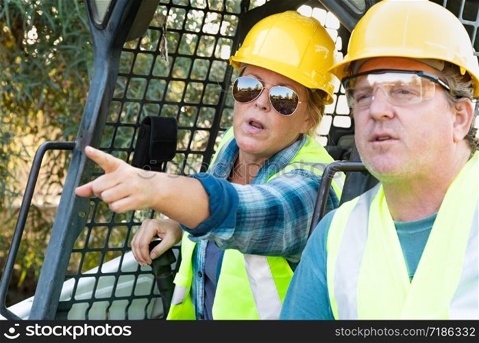 Male and Female Workers Talking at Construction Site