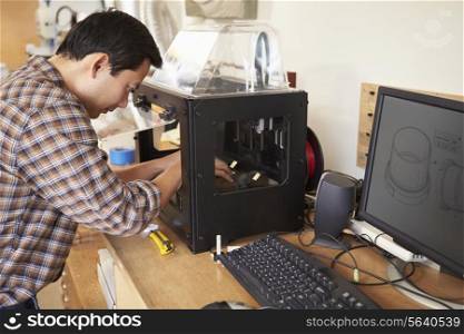Male Architect Using 3D Printer In Office