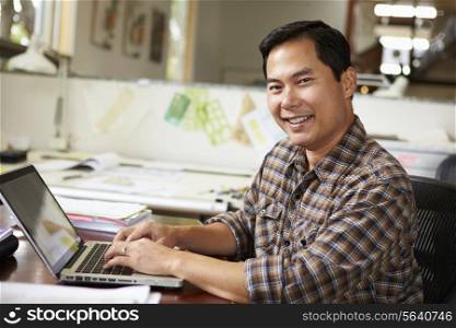 Male Architect Working At Desk On Laptop