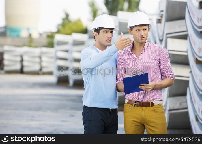 Male architects inspecting inventory at site