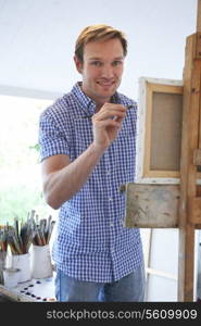 Male Artist Painting In Studio