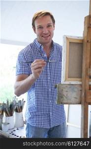 Male Artist Painting In Studio