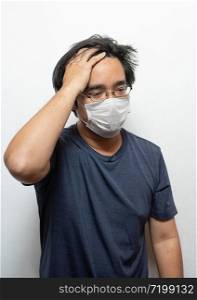 Male Asian patient wearing surgical mask feeling sick headache and coughing isolated on white background.Wuhan coronavirus (COVID-19) outbreak prevention. Health care concept