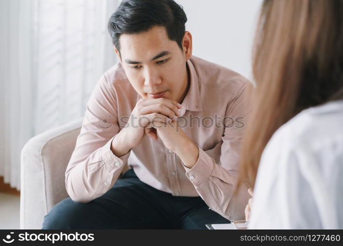 Male Asian patient with psychologist women examination consulting and psychotherapy by the physician in the clinic. psychiatrist concept