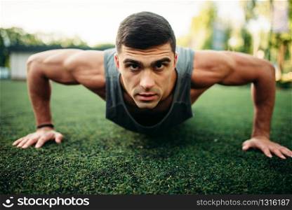 Male athlete doing push-up exercise outdoor, fitness workout. Sportsman on fit training in park