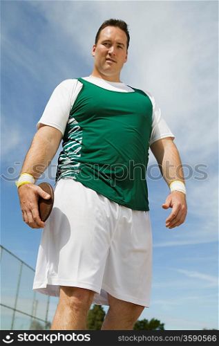 Male athlete holding discus, portrait