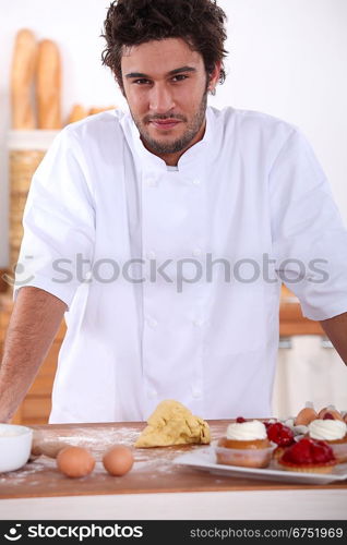 Male baker making sweet cakes