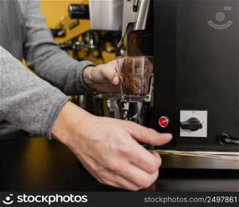 male barista grinding coffee coffee shop