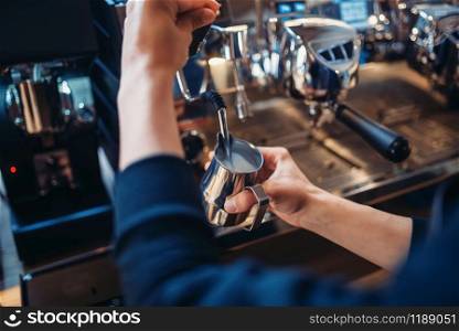 Male barista prepares beverage on coffee machine in cafe. Professional espresso preparation by barman. Male barista prepares beverage on coffee machine