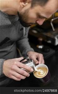 male barista preparing coffee