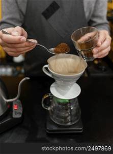 male barista putting coffee filter