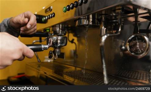male barista using professional coffee machine